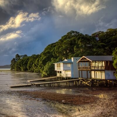 Beach house near water on a cloudy day