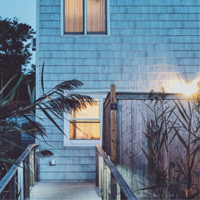 Walkway towards a house with light-up windows