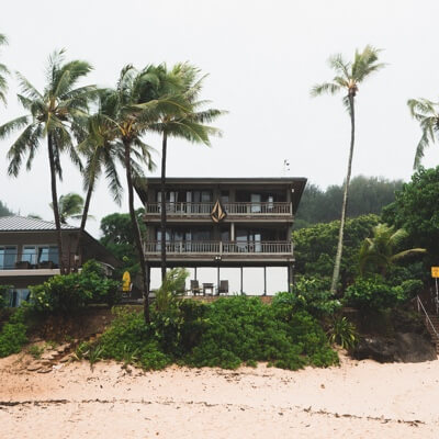 Beach house surrounded by palm trees