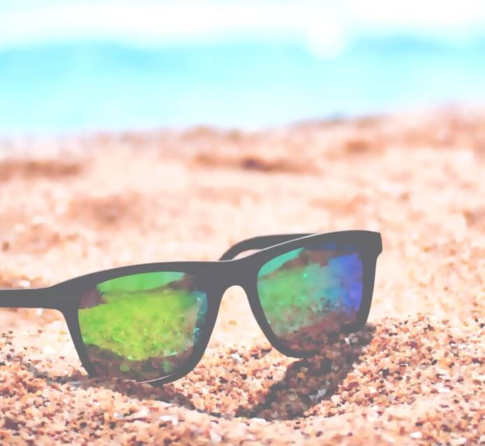 Sunglasses on beach sand