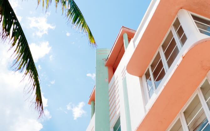 Tall white building with palm tree