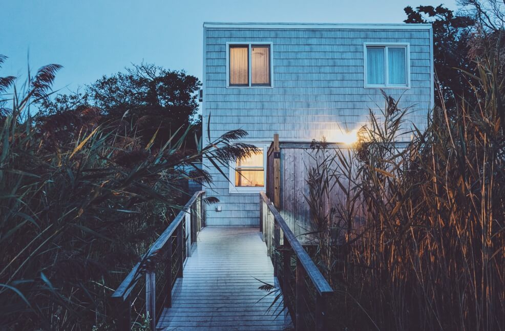 Walkway towards a house with light-up windows